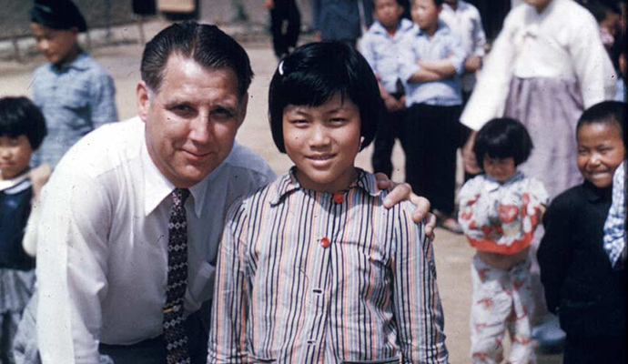 Everett Swanson smiles witha Korean child