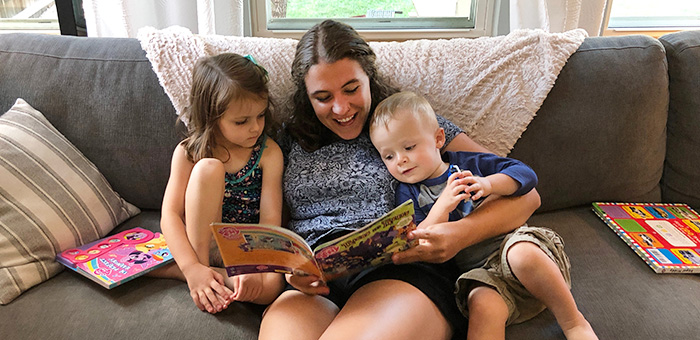 An intern reads to the children in the home she stays at