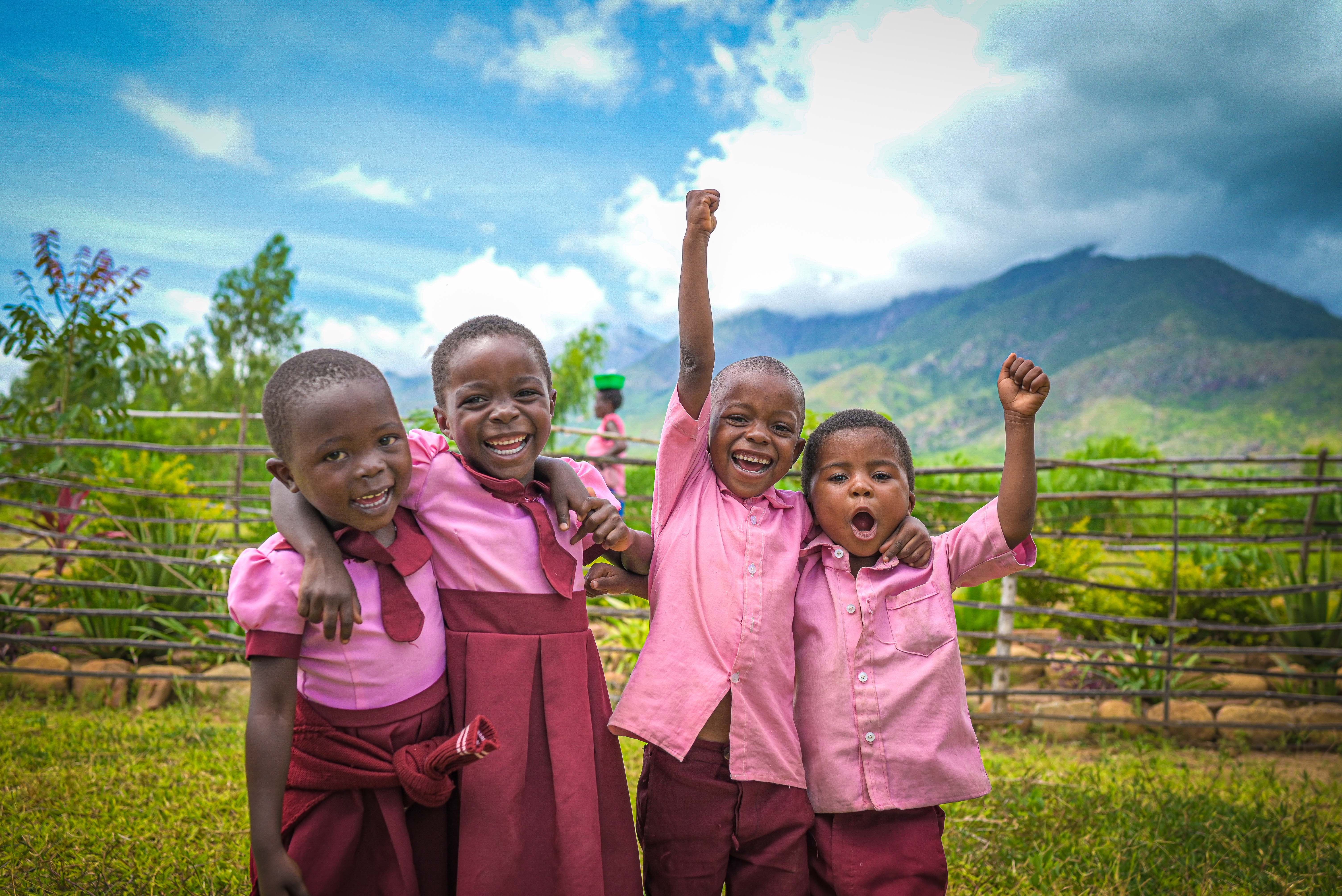 Children cheering together and smiling