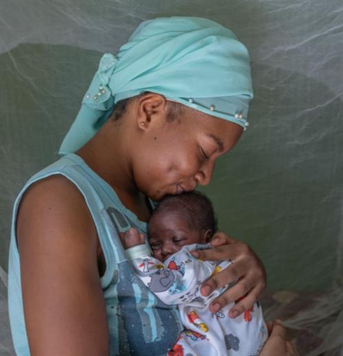 A mother holding her baby