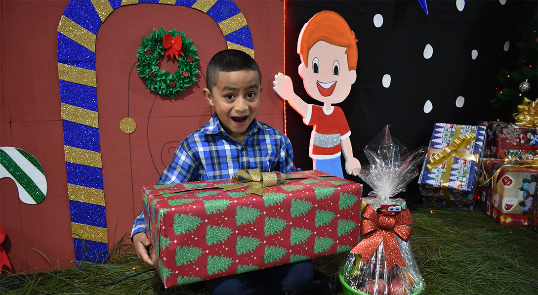 Jose holds gift excitedly