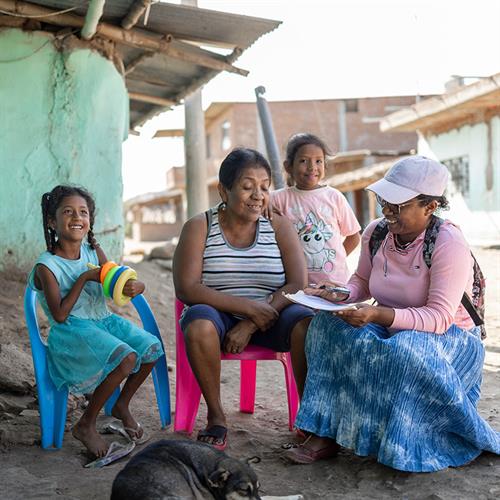 women and children sit and talk