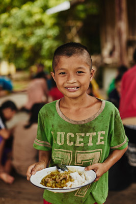 Young boy holding plate of food