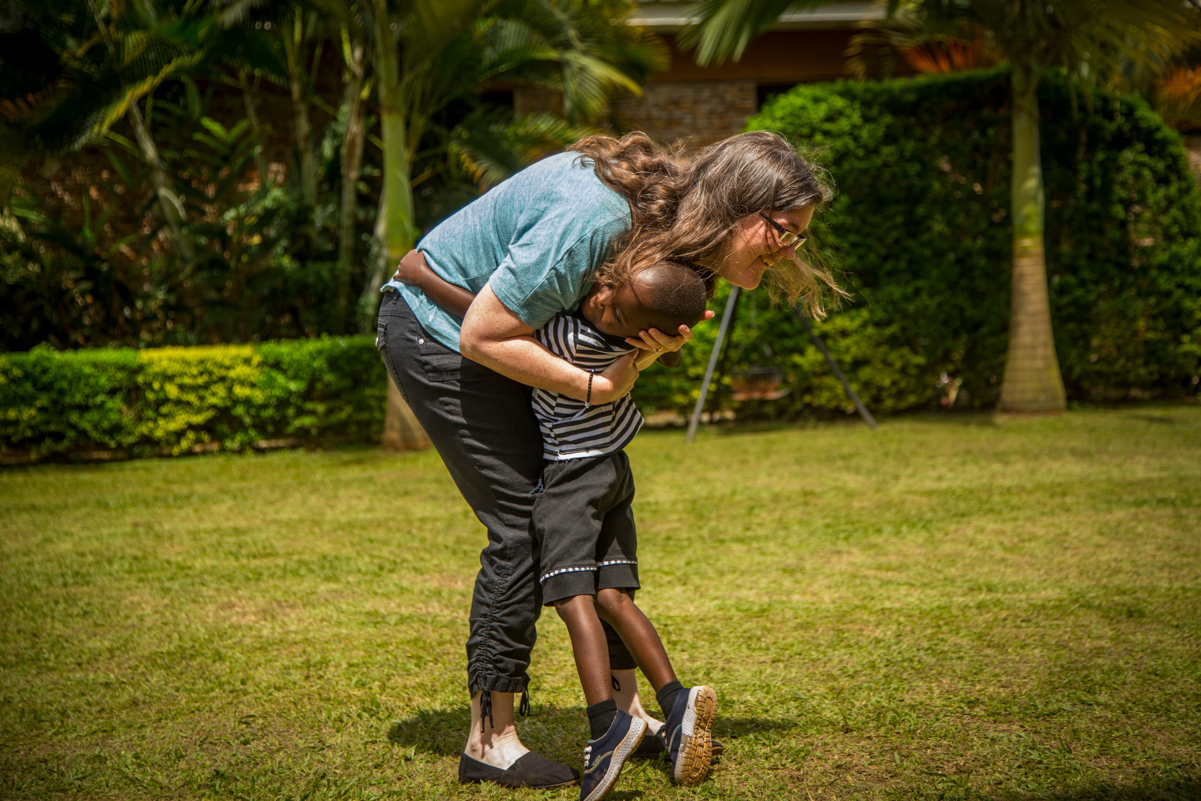 A young boy is hugging his Compassion sponsor.