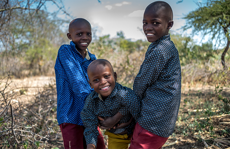 Kasola and his brothers smiling